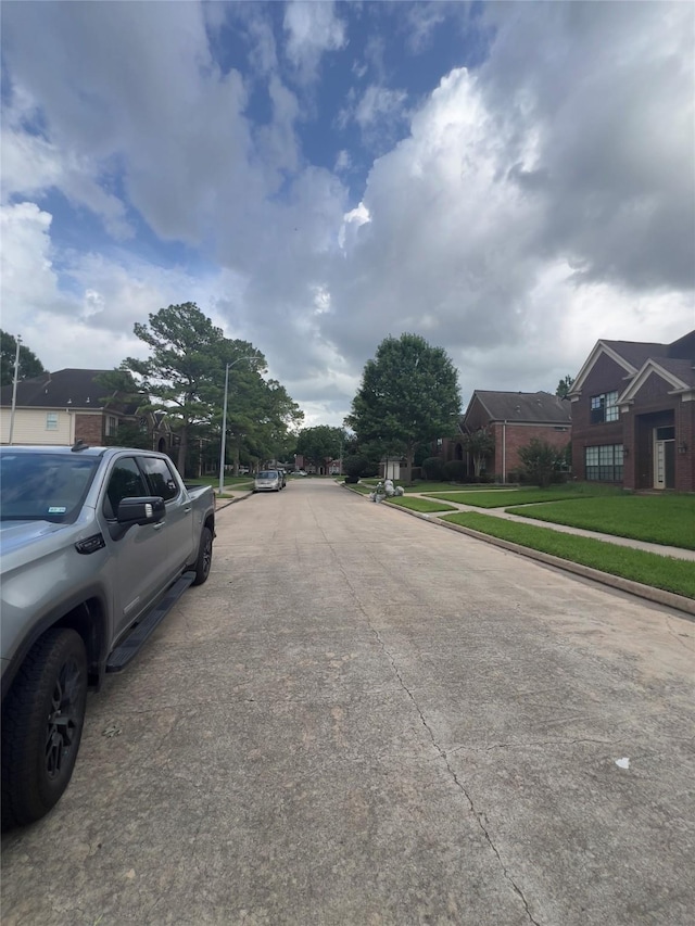 18703 Evergreen Falls Dr, Houston, TX 77084 - view of concrete street with sidewalks, curbs, and a residential view