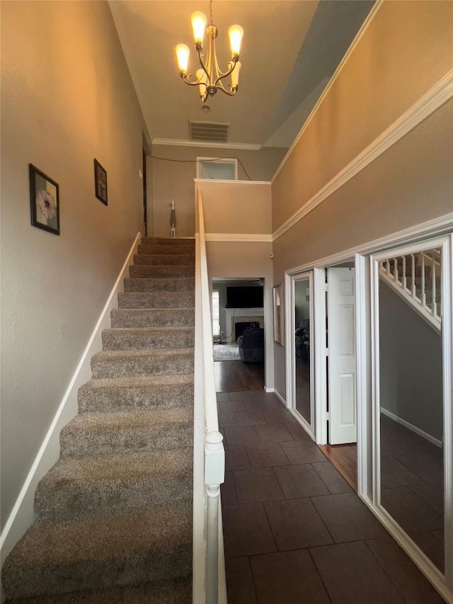 18703 Evergreen Falls Dr, Houston, TX 77084 - staircase with a chandelier, a towering ceiling, and tile patterned floors