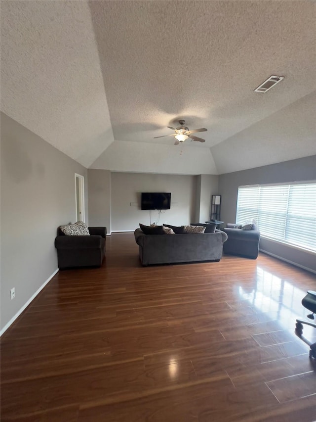 18703 Evergreen Falls Dr, Houston, TX 77084 - living area featuring vaulted ceiling, ceiling fan, wood finished floors, and a textured ceiling