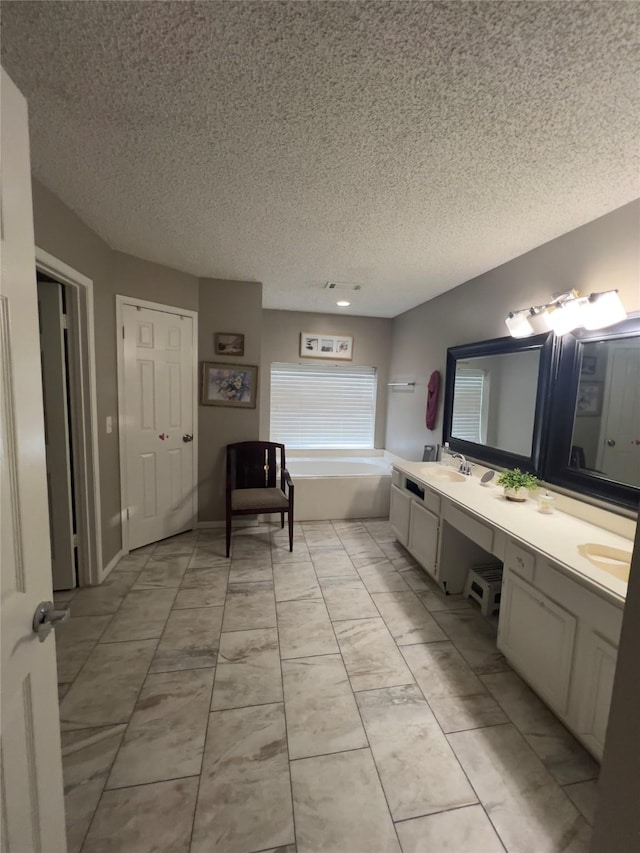 18703 Evergreen Falls Dr, Houston, TX 77084 - full bath featuring a textured ceiling, double vanity, a bath, and tile patterned floors