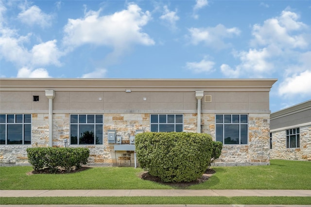 440 Cobia Dr Unit 1804, Katy, TX 77494 - view of side of home featuring stone siding and a lawn