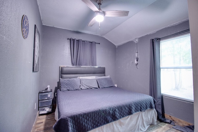 1226 Rd 5007, Cleveland, TX 77327 - bedroom with wood finished floors, multiple windows, lofted ceiling, a textured wall, and a ceiling fan