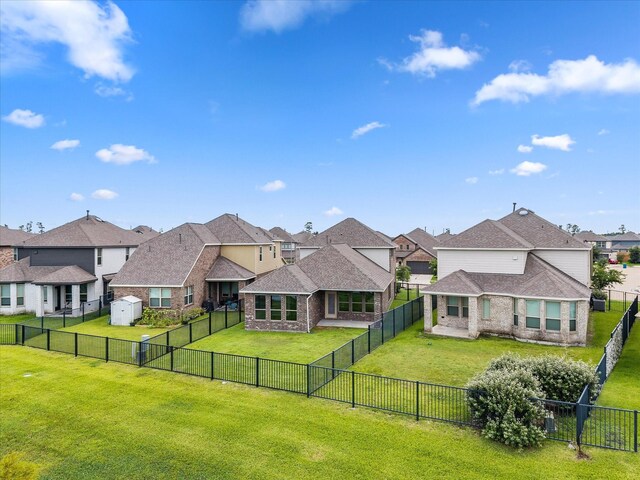 15754 Cairnwell Bend Dr, Humble, TX 77346 - back of house with a residential view, brick siding, a fenced backyard, and a shingled roof