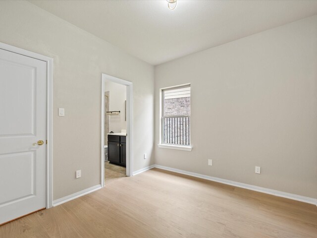15754 Cairnwell Bend Dr, Humble, TX 77346 - unfurnished bedroom featuring light wood-style floors and ensuite bathroom