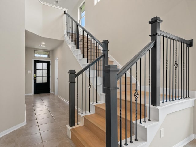 15754 Cairnwell Bend Dr, Humble, TX 77346 - stairway featuring tile patterned floors and a towering ceiling