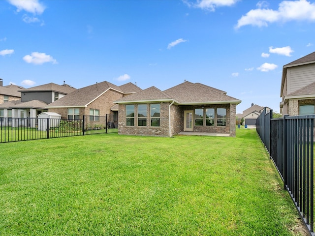 15754 Cairnwell Bend Dr, Humble, TX 77346 - rear view of house featuring brick siding, a fenced backyard, and roof with shingles