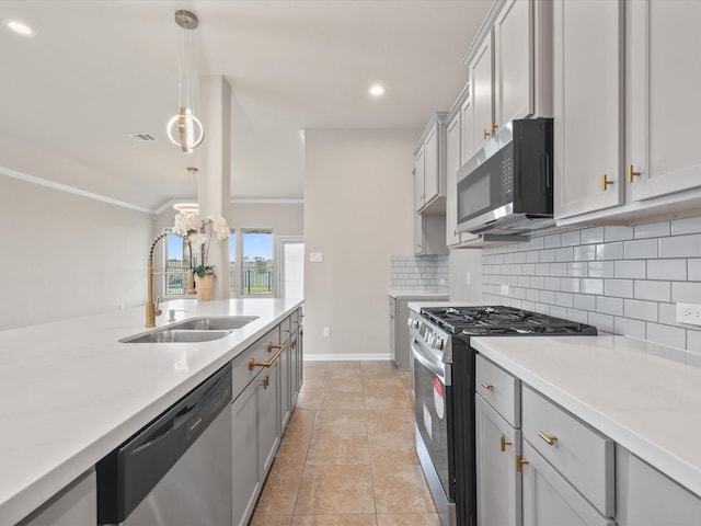 15754 Cairnwell Bend Dr, Humble, TX 77346 - kitchen featuring stainless steel appliances, decorative backsplash, decorative light fixtures, gray cabinetry, and recessed lighting