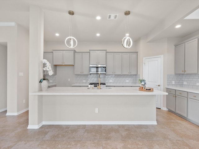 15754 Cairnwell Bend Dr, Humble, TX 77346 - kitchen featuring stainless steel microwave, gray cabinets, light countertops, decorative backsplash, and recessed lighting