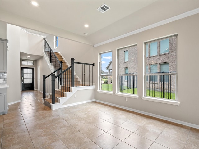 15754 Cairnwell Bend Dr, Humble, TX 77346 - unfurnished room with stairs, light tile patterned floors, ornamental molding, recessed lighting, and lofted ceiling