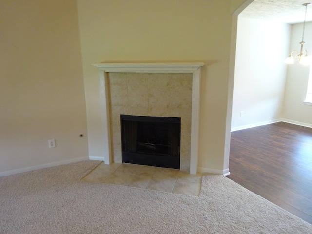 21606 Haylee Way, Humble, TX 77338 - detailed view of a chandelier, a fireplace, carpet, and arched walkways