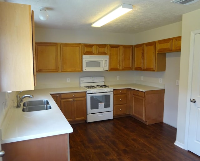 21606 Haylee Way, Humble, TX 77338 - kitchen featuring white appliances, dark wood-style floors, brown cabinets, and light countertops