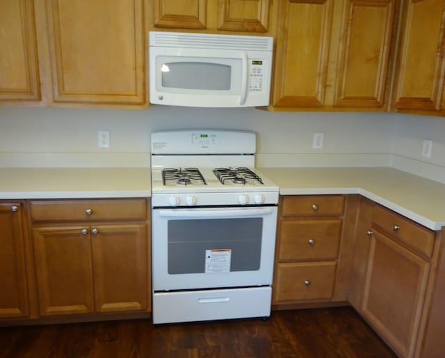 21606 Haylee Way, Humble, TX 77338 - kitchen featuring white appliances, light countertops, dark wood-type flooring, and brown cabinetry