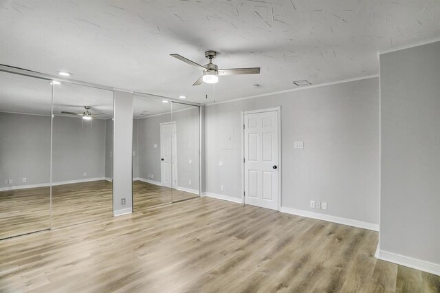 709 Gale St Unit 14, Seabrook, TX 77586 - unfurnished bedroom with multiple closets, ornamental molding, wood finished floors, recessed lighting, and a ceiling fan