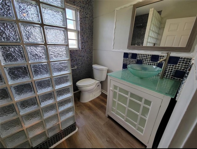 709 Gale St Unit 14, Seabrook, TX 77586 - bathroom with a walk in shower, wood finished floors, vanity, and decorative backsplash
