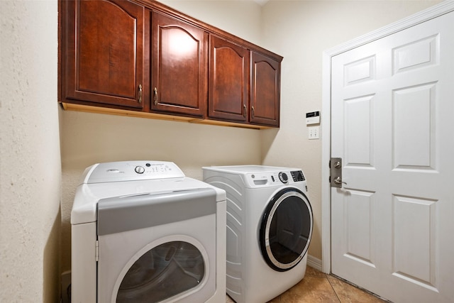 15590 Crown Oaks Dr, Montgomery, TX 77316 - laundry room with independent washer and dryer, cabinet space, and light tile patterned flooring