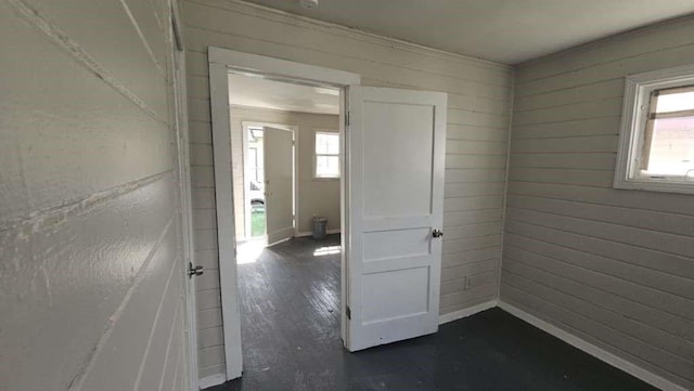 6909 Kittridge St, Houston, TX 77028 - spare room featuring plenty of natural light, dark wood-type flooring, wood walls, and ornamental molding