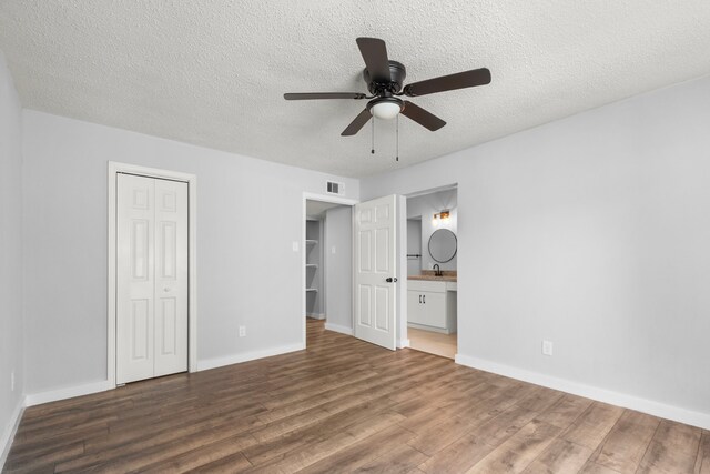 16234 Bowridge Ln, Houston, TX 77053 - unfurnished bedroom with wood finished floors, a textured ceiling, a closet, ensuite bath, and a ceiling fan