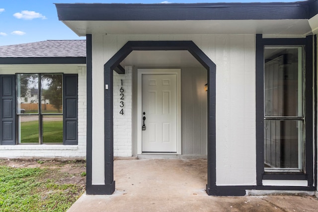 16234 Bowridge Ln, Houston, TX 77053 - doorway to property with a shingled roof and brick siding