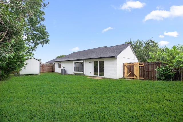 16234 Bowridge Ln, Houston, TX 77053 - back of house with a storage shed, a fenced backyard, brick siding, and roof with shingles