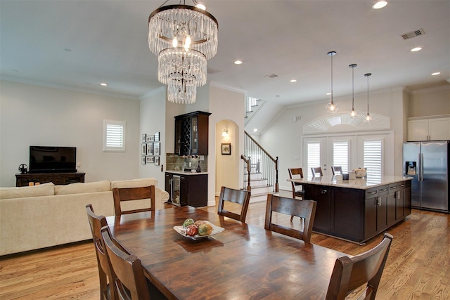 4314 Gibson St Unit B, Houston, TX 77007 - dining room featuring stairway, healthy amount of natural light, light wood-style floors, recessed lighting, and a chandelier