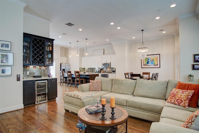 4314 Gibson St Unit B, Houston, TX 77007 - living room with beverage cooler, a dry bar, wood finished floors, ornamental molding, and recessed lighting