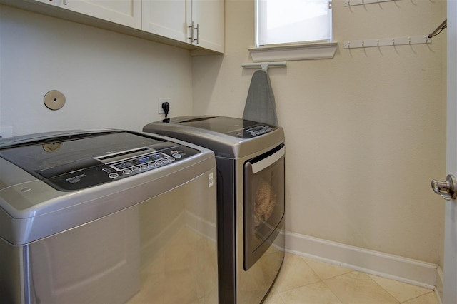 4314 Gibson St Unit B, Houston, TX 77007 - laundry area with cabinet space, independent washer and dryer, and light tile patterned floors