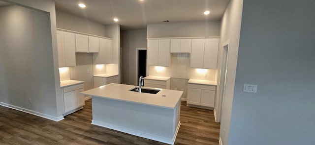 2556 Newport Breeze Dr, Katy, TX 77493 - kitchen with dark wood finished floors, a center island with sink, white cabinetry, recessed lighting, and light countertops