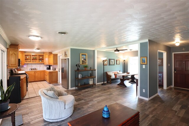 1205 Carmie St, Alvin, TX 77511 - living area featuring crown molding, a ceiling fan, and wood finished floors