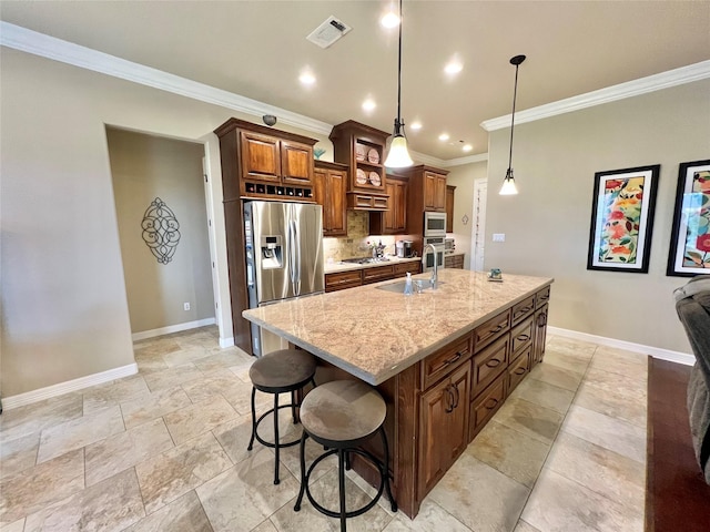 1464 S Bluebonnet Ln, Angleton, TX 77515 - kitchen featuring stainless steel appliances, ornamental molding, an island with sink, a breakfast bar area, and decorative backsplash