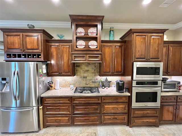 1464 S Bluebonnet Ln, Angleton, TX 77515 - kitchen with appliances with stainless steel finishes, ornamental molding, decorative backsplash, light stone counters, and recessed lighting