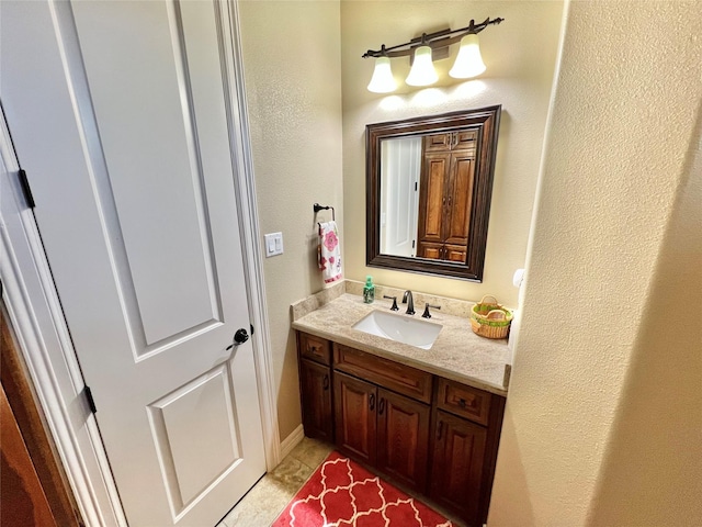 1464 S Bluebonnet Ln, Angleton, TX 77515 - bathroom with vanity and a textured wall