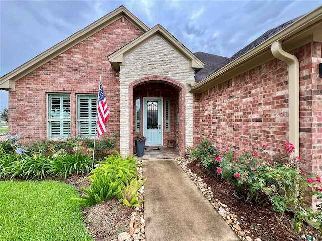 1464 S Bluebonnet Ln, Angleton, TX 77515 - doorway to property with brick siding and roof with shingles