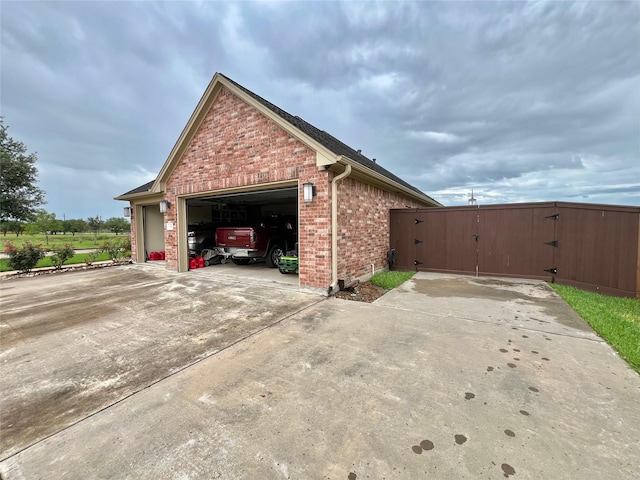 1464 S Bluebonnet Ln, Angleton, TX 77515 - view of side of home featuring brick siding, a gate, a garage, and driveway