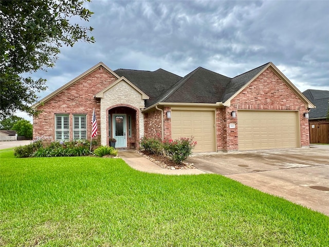 1464 S Bluebonnet Ln, Angleton, TX 77515 - traditional-style house with a garage, a front yard, concrete driveway, brick siding, and roof with shingles