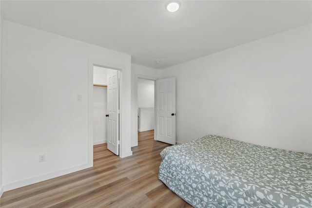 8211 Barlow St, Houston, TX 77028 - bedroom with wood finished floors and a walk in closet