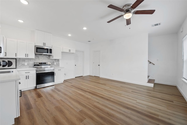8211 Barlow St, Houston, TX 77028 - kitchen featuring stainless steel appliances, light countertops, ceiling fan, recessed lighting, and tasteful backsplash