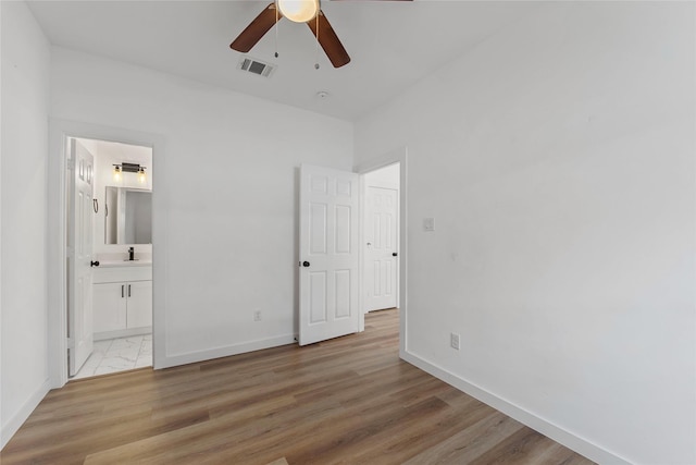 8211 Barlow St, Houston, TX 77028 - unfurnished bedroom with light wood-type flooring, ensuite bath, and ceiling fan