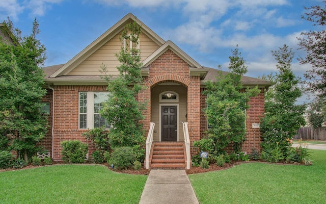 931 Shirkmere Rd, Houston, TX 77008 - view of front of house with brick siding, a front yard, and roof with shingles