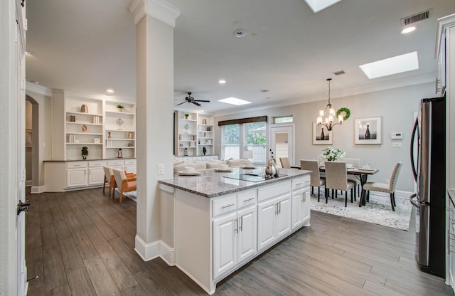 931 Shirkmere Rd, Houston, TX 77008 - kitchen with a skylight, freestanding refrigerator, dark wood finished floors, light stone countertops, and open floor plan