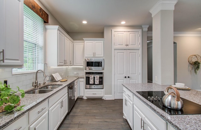 931 Shirkmere Rd, Houston, TX 77008 - kitchen featuring appliances with stainless steel finishes, white cabinetry, dark wood-type flooring, backsplash, and light stone countertops