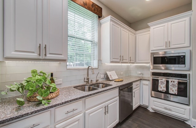 931 Shirkmere Rd, Houston, TX 77008 - kitchen with stainless steel appliances, white cabinets, light stone counters, and decorative backsplash