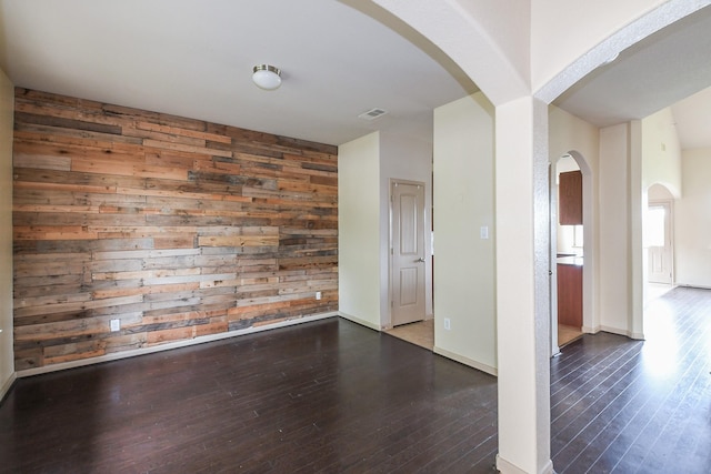 6533 Gray Birch Ln, Dickinson, TX 77539 - spare room featuring hardwood / wood-style flooring, wood walls, and arched walkways