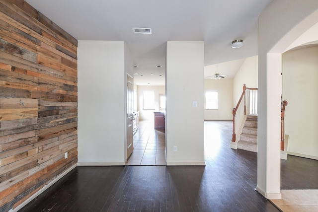 6533 Gray Birch Ln, Dickinson, TX 77539 - unfurnished room featuring wooden walls, a ceiling fan, hardwood / wood-style floors, stairway, and arched walkways
