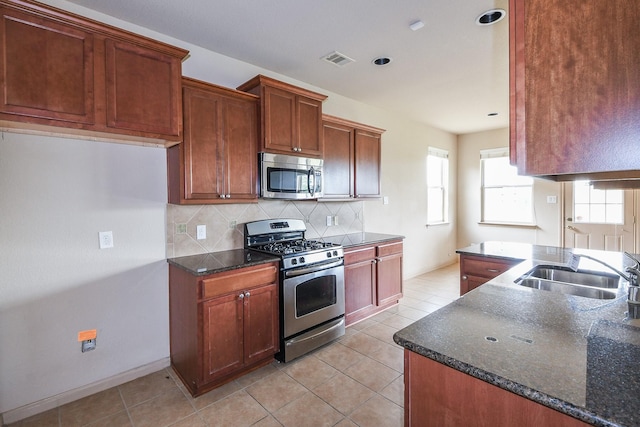 6533 Gray Birch Ln, Dickinson, TX 77539 - kitchen with appliances with stainless steel finishes, healthy amount of natural light, tasteful backsplash, light tile patterned floors, and recessed lighting