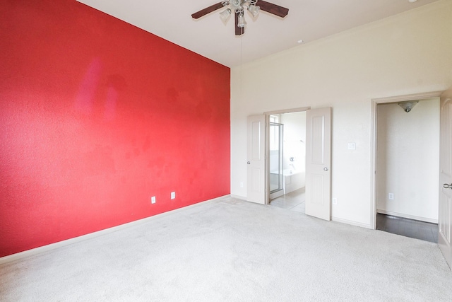 6533 Gray Birch Ln, Dickinson, TX 77539 - unfurnished bedroom featuring carpet floors, connected bathroom, a towering ceiling, and ceiling fan