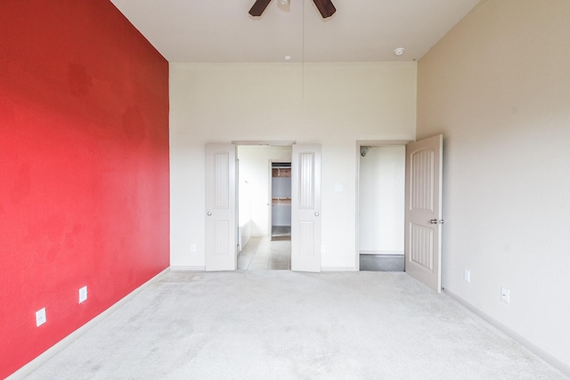 6533 Gray Birch Ln, Dickinson, TX 77539 - unfurnished bedroom featuring carpet floors, a walk in closet, a towering ceiling, and a ceiling fan