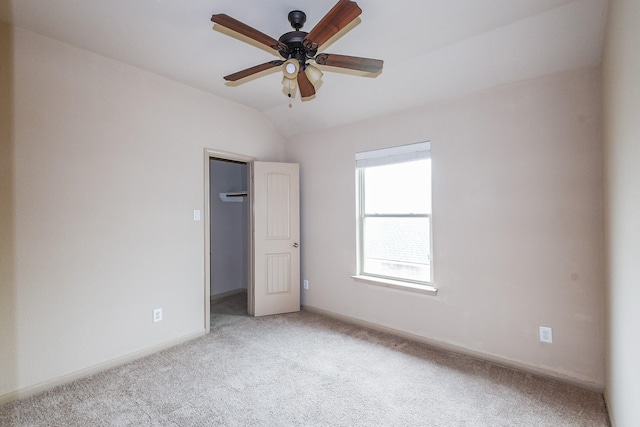 6533 Gray Birch Ln, Dickinson, TX 77539 - unfurnished bedroom with light carpet, vaulted ceiling, a spacious closet, a closet, and a ceiling fan