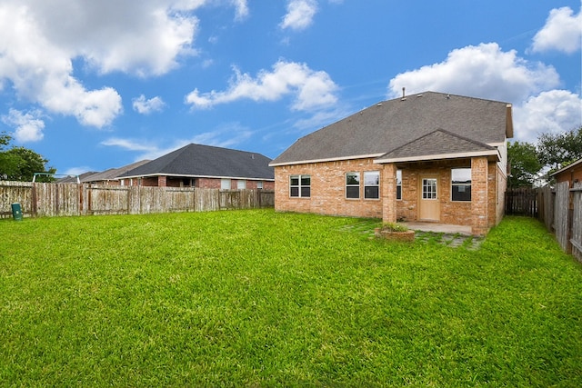 6533 Gray Birch Ln, Dickinson, TX 77539 - back of house with a patio, a fenced backyard, a shingled roof, and brick siding