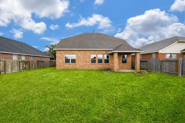 6533 Gray Birch Ln, Dickinson, TX 77539 - rear view of house featuring a fenced backyard, a patio, brick siding, and roof with shingles