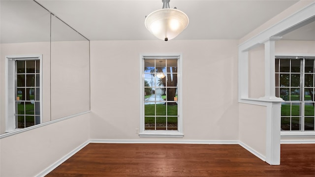 9643 Val Verde St, Houston, TX 77063 - unfurnished dining area with wood finished floors, healthy amount of natural light, and decorative columns